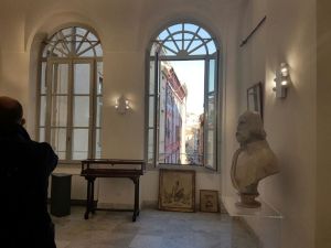 Interior: a salon with a view of the palace next door and the bust of Garibaldi