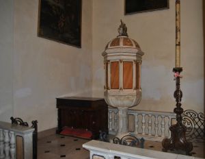 The baptismal font with ciborium and entrance to the basement